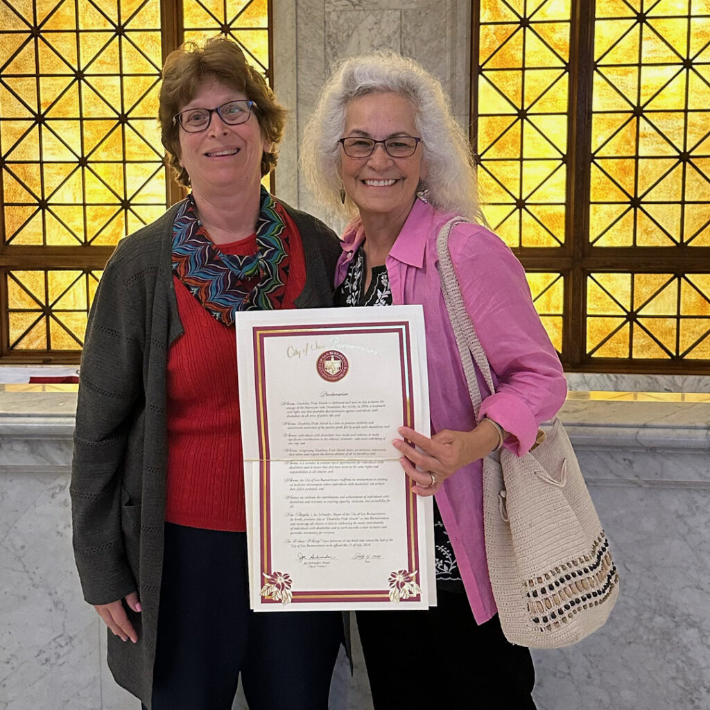 Carol Leish and Dr. Maria Muquila accepting the proclamation of disability pride month